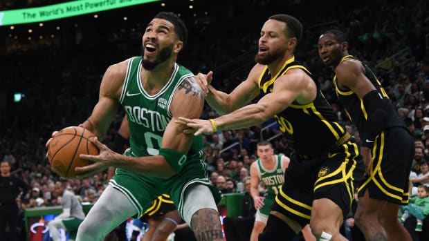 Jayson Tatum is guarded by Stephen Curry